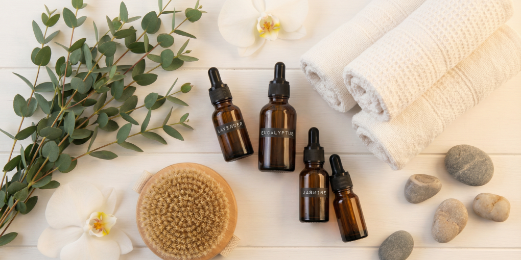 Natural wellness self-care tools with essential oils and flowers - Noogleberry Review